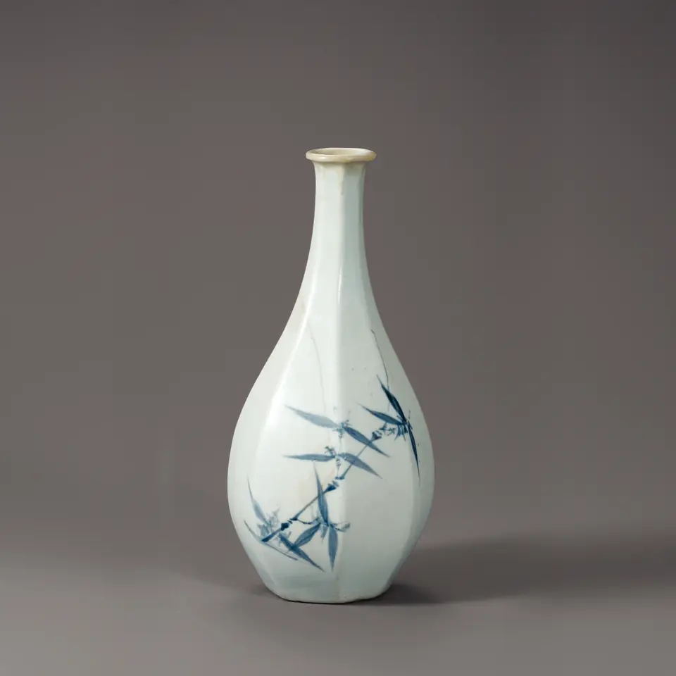 Slender white porcelain bottle painted with blue bamboo leaves