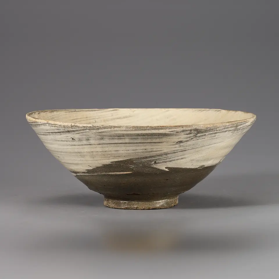 Wide buncheong tea bowl, dark clay swept with a fast brush of white slip